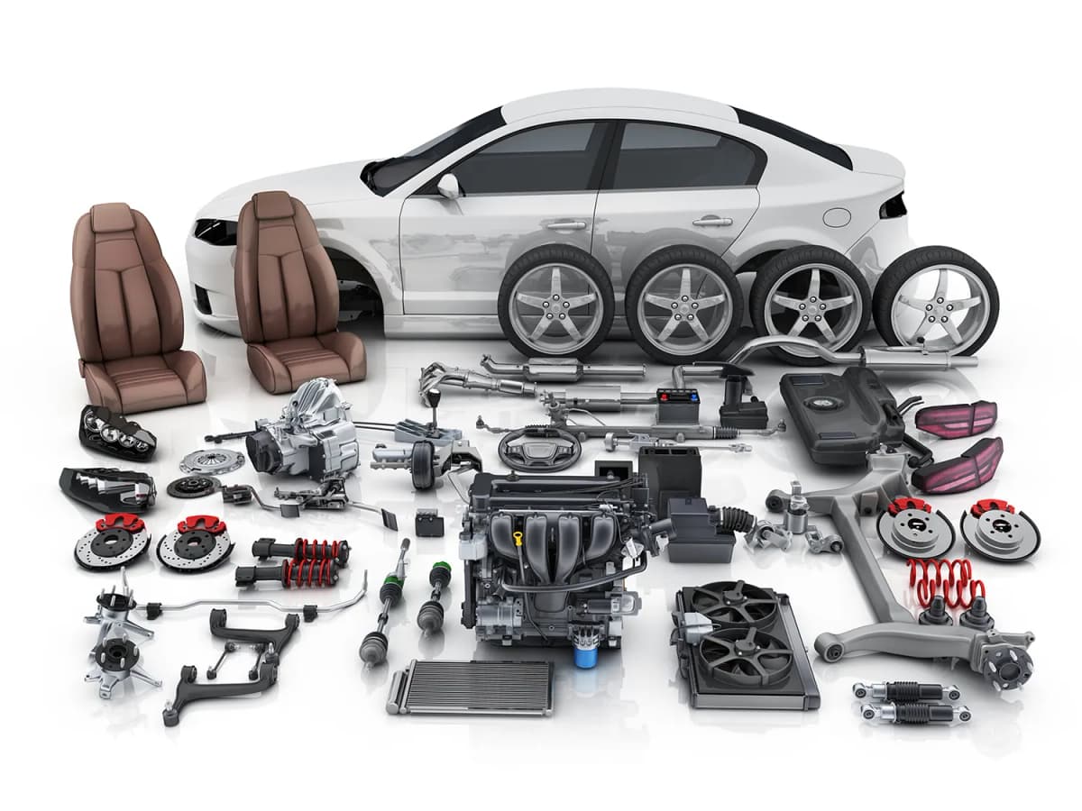 Used OEM auto parts laid out, including engine, wheels, brakes and body parts